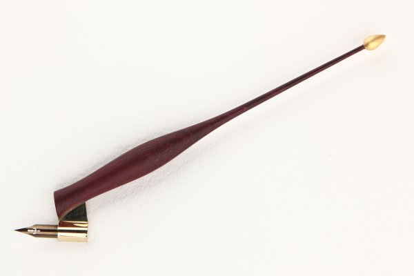 Oblique pen holder made of Purpleheart wood with gilded finial.